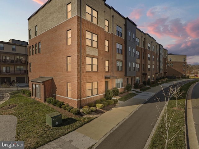 view of outdoor building at dusk