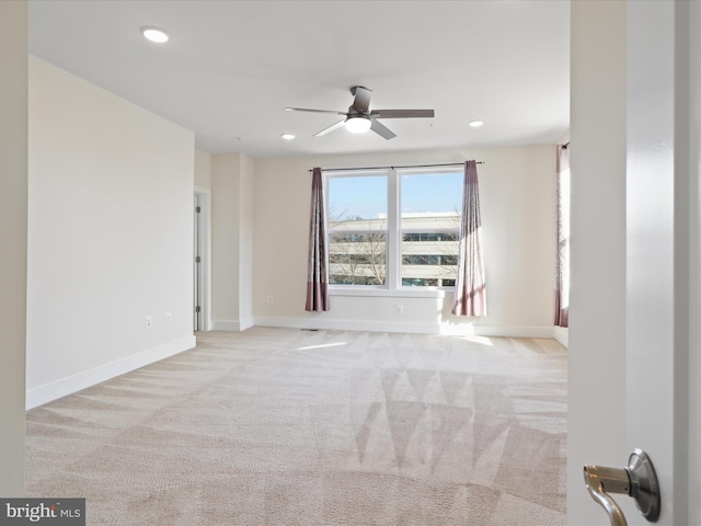carpeted empty room featuring ceiling fan