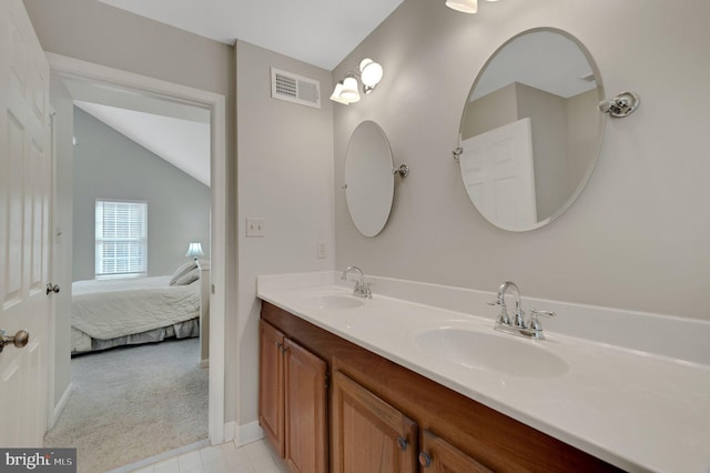 full bathroom with vaulted ceiling, a sink, visible vents, and connected bathroom