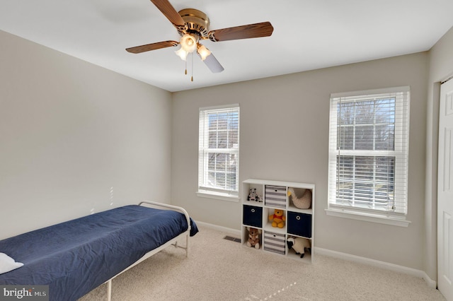 bedroom featuring ceiling fan, carpet, and baseboards