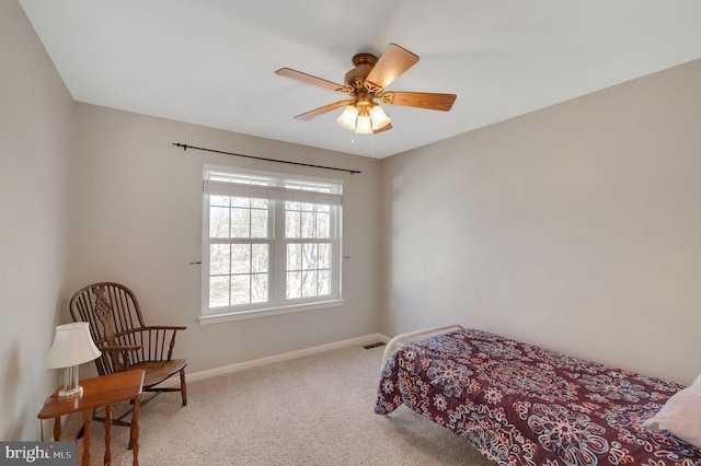 carpeted bedroom featuring ceiling fan and baseboards