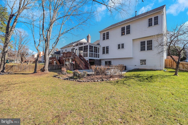 rear view of property featuring a sunroom, a fenced backyard, stairs, and a chimney