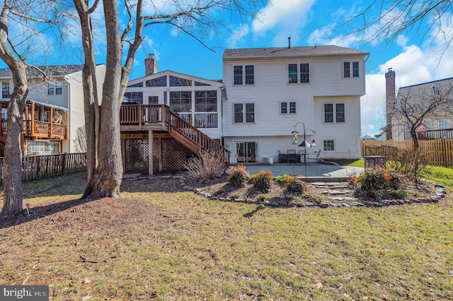 back of property featuring a patio, a sunroom, fence, a wooden deck, and stairs