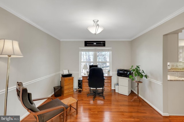 office space featuring baseboards, wood finished floors, and ornamental molding