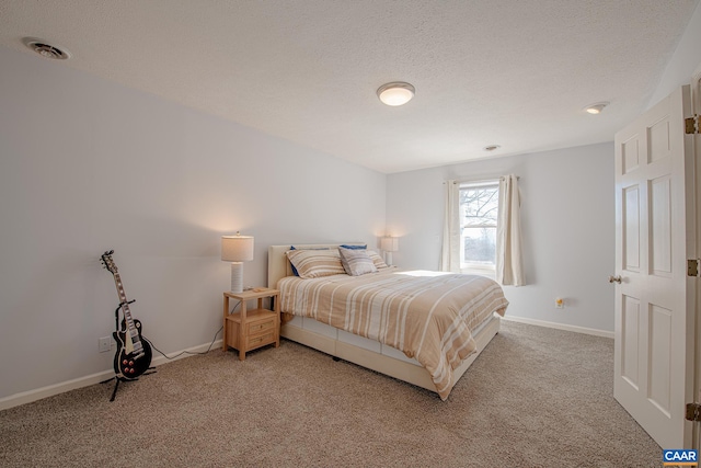 bedroom with carpet floors and a textured ceiling