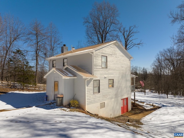 snow covered property with central air condition unit