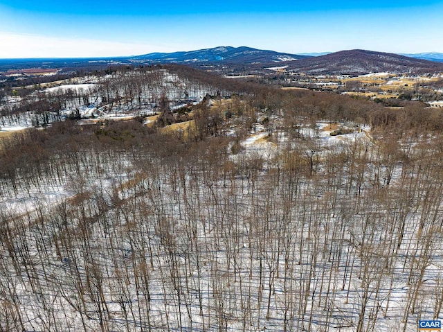 snowy aerial view with a mountain view