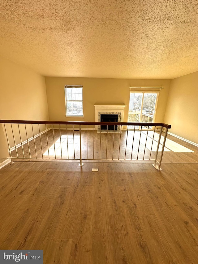 interior space with wood-type flooring and a textured ceiling