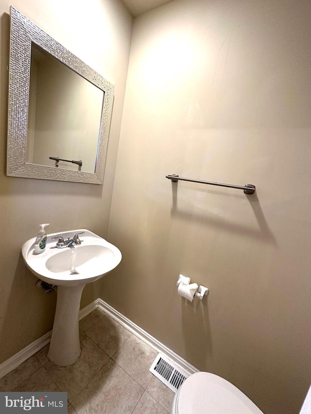 bathroom with tile patterned flooring and toilet