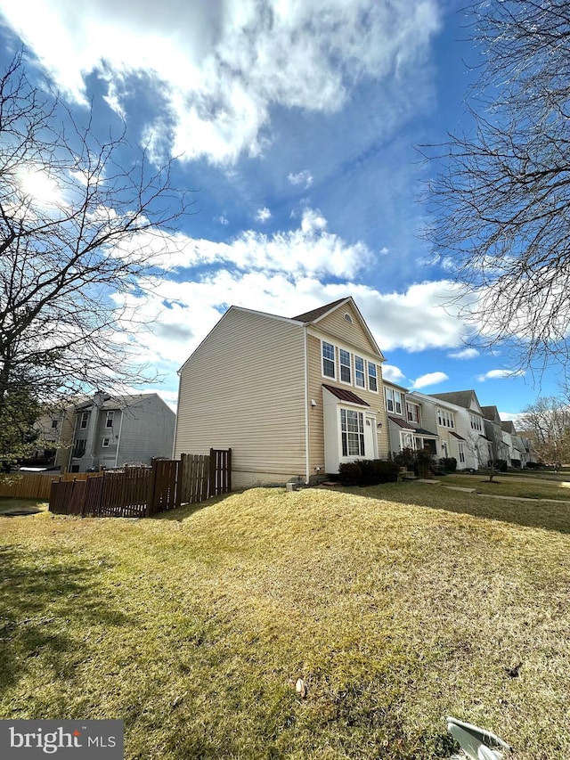 view of side of property with a yard