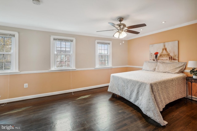 bedroom featuring ornamental molding, wood finished floors, a ceiling fan, and baseboards