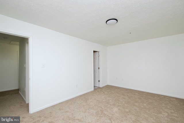 carpeted spare room with a textured ceiling