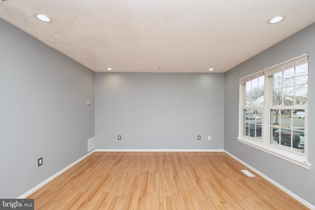 empty room with light hardwood / wood-style floors