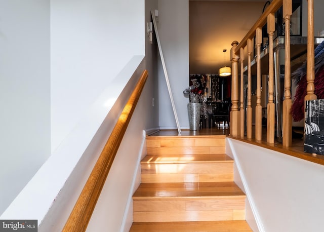 stairs featuring baseboards and wood finished floors