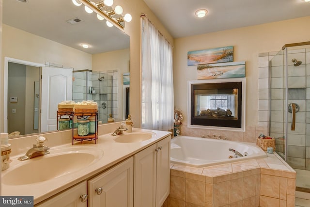 bathroom with a garden tub, a sink, visible vents, and a shower stall