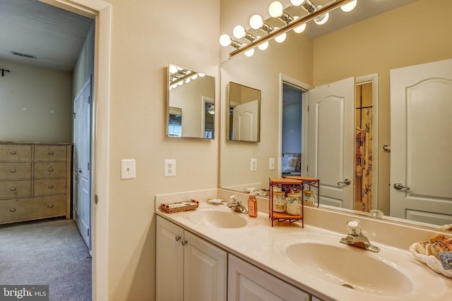 bathroom featuring a sink and double vanity