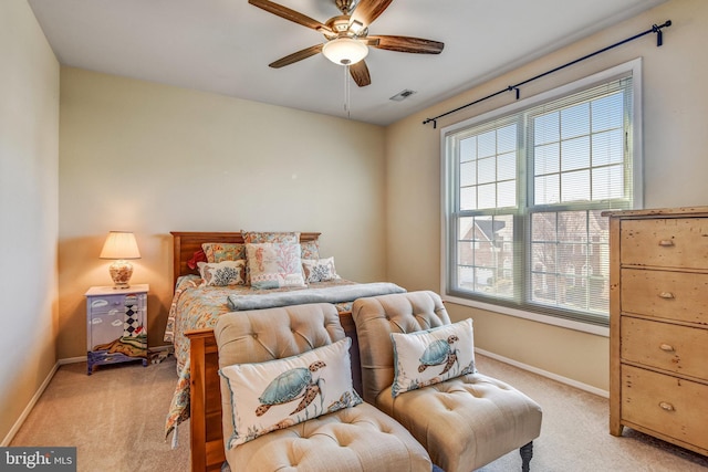 bedroom featuring visible vents, light carpet, and baseboards