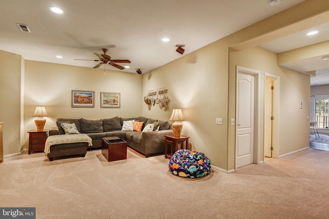 living area featuring recessed lighting, visible vents, baseboards, and light colored carpet