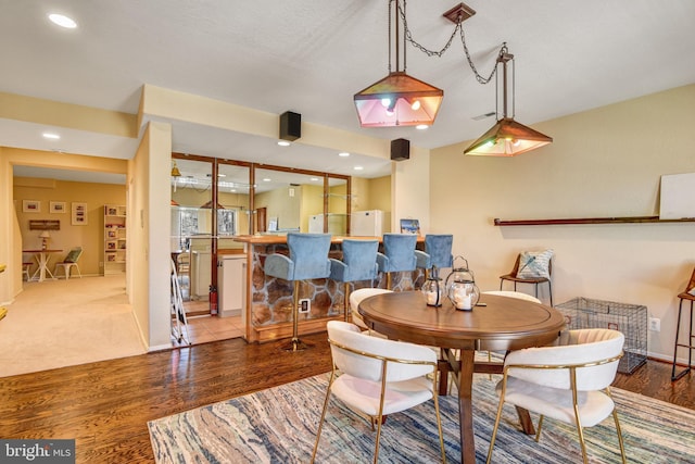 dining area featuring recessed lighting, baseboards, and wood finished floors