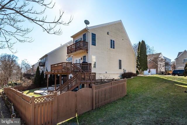 rear view of house featuring stairs, a lawn, fence private yard, and a balcony