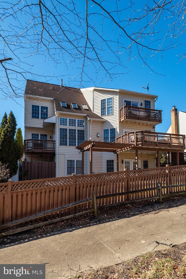 back of property featuring a fenced front yard