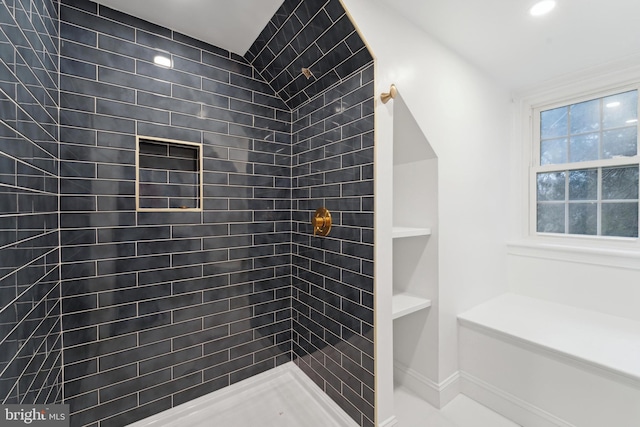 bathroom featuring tiled shower and built in features