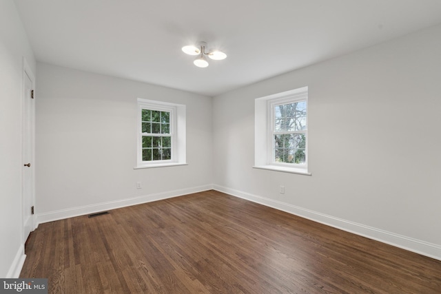 empty room with dark hardwood / wood-style floors