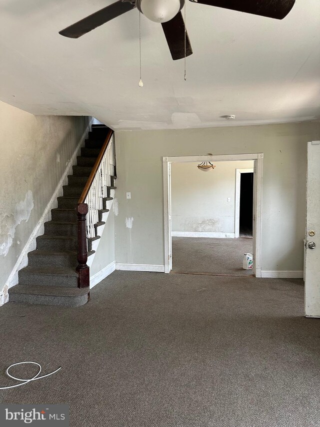 1428 W State St, Trenton, NJ 08618 - unfurnished living room with carpet floors, stairway, and ceiling fan