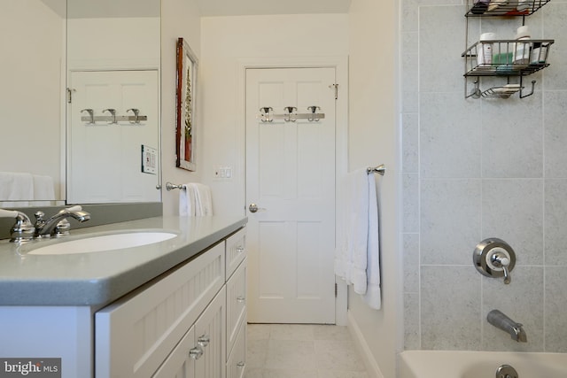 bathroom featuring tile patterned floors, shower / washtub combination, and vanity