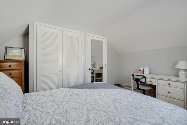 bedroom with lofted ceiling and a closet