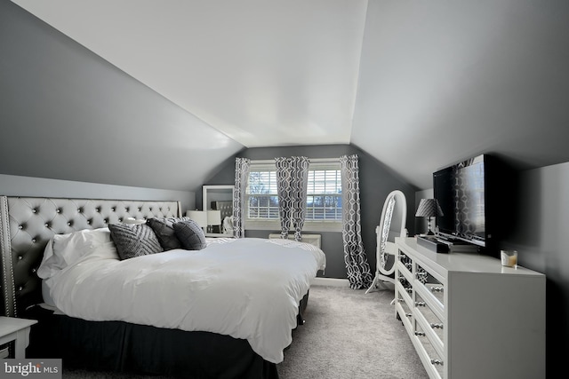 bedroom featuring lofted ceiling, baseboards, and light colored carpet