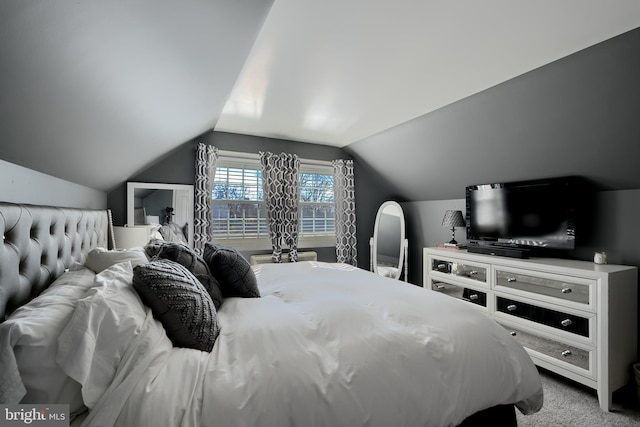 bedroom featuring carpet floors and lofted ceiling