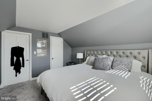 carpeted bedroom with vaulted ceiling and visible vents