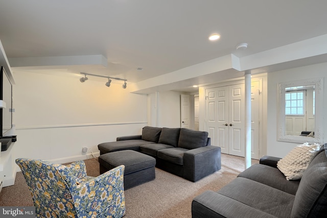 carpeted living room with baseboards and track lighting