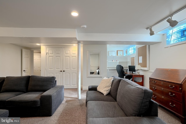 carpeted living room featuring track lighting