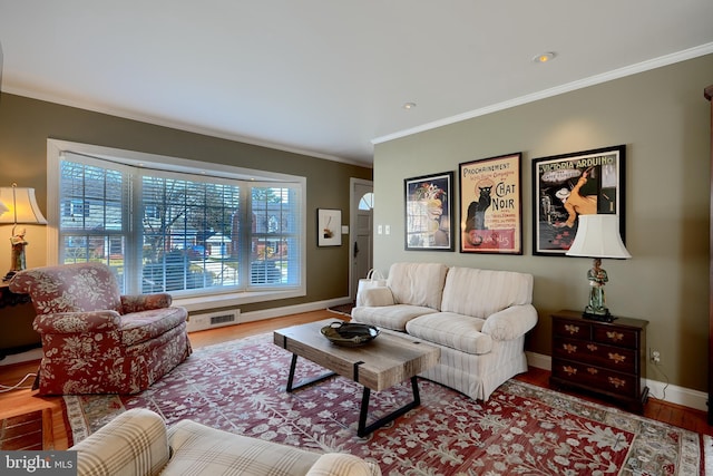 living area with visible vents, crown molding, baseboards, and wood finished floors