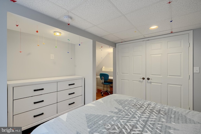 bedroom featuring a closet and a drop ceiling