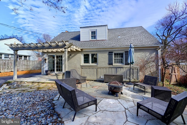 back of property featuring an outdoor fire pit, a shingled roof, a patio, fence, and brick siding