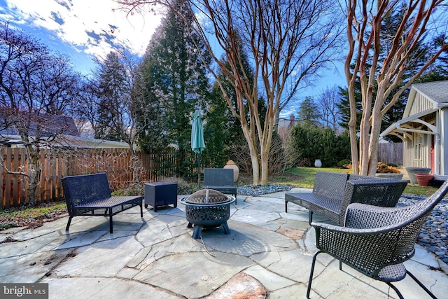 view of patio with a fenced backyard and a fire pit