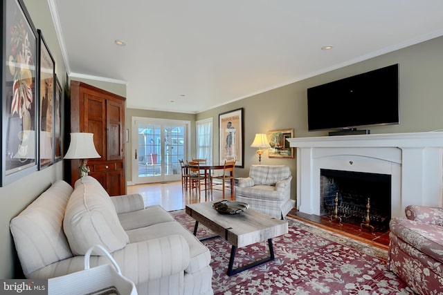 living room with crown molding and wood finished floors