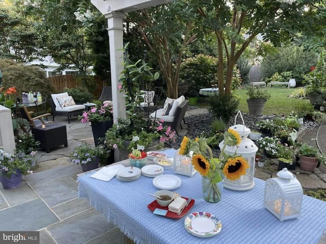 view of patio featuring outdoor dining space and fence