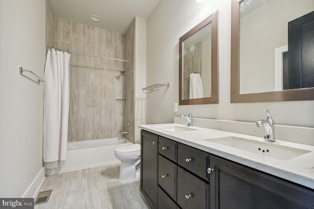 full bathroom with shower / bathtub combination with curtain, vanity, and toilet