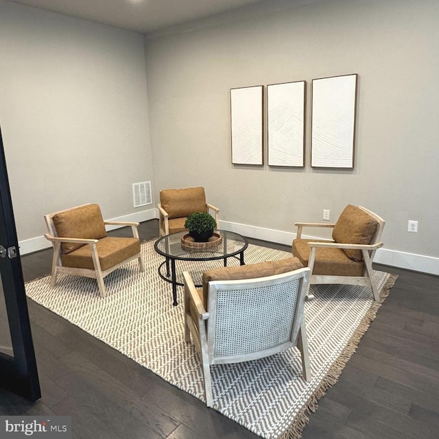 sitting room with dark hardwood / wood-style floors