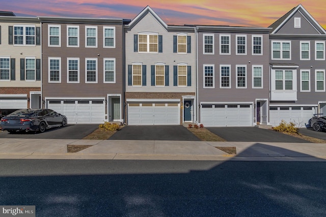 view of property with driveway and an attached garage