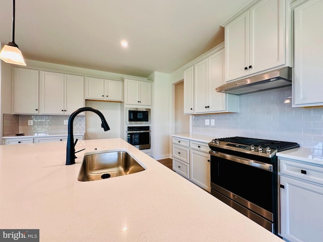 kitchen featuring pendant lighting, white cabinetry, appliances with stainless steel finishes, and sink