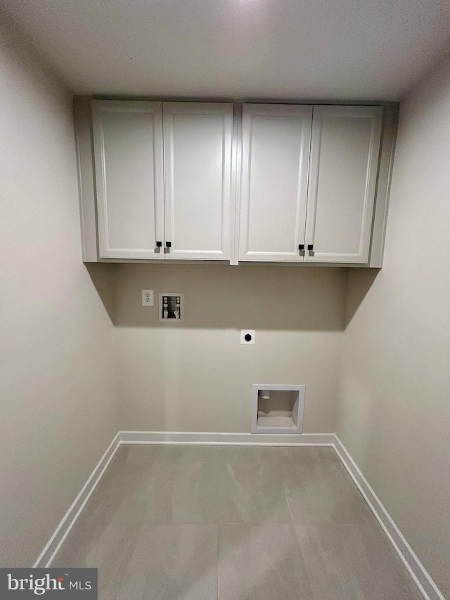 washroom featuring cabinets, washer hookup, and electric dryer hookup