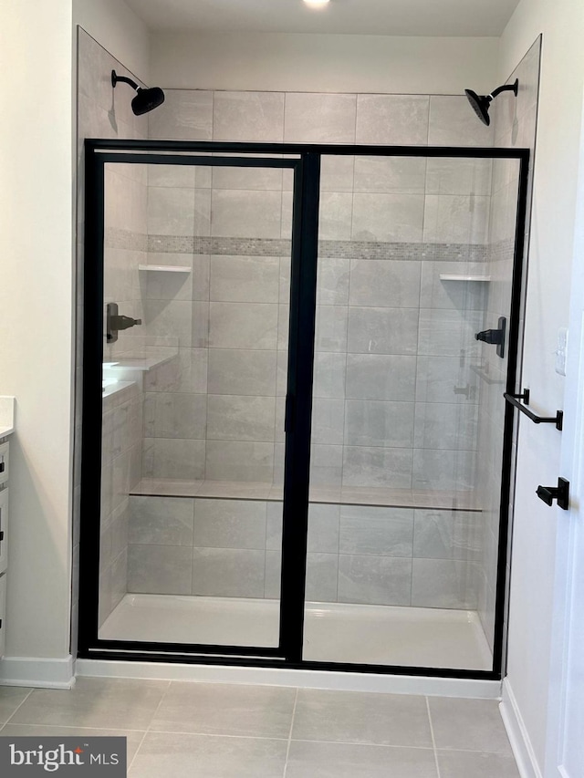 bathroom featuring vanity, an enclosed shower, and tile patterned flooring