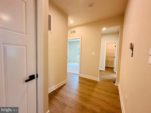 corridor with light hardwood / wood-style flooring