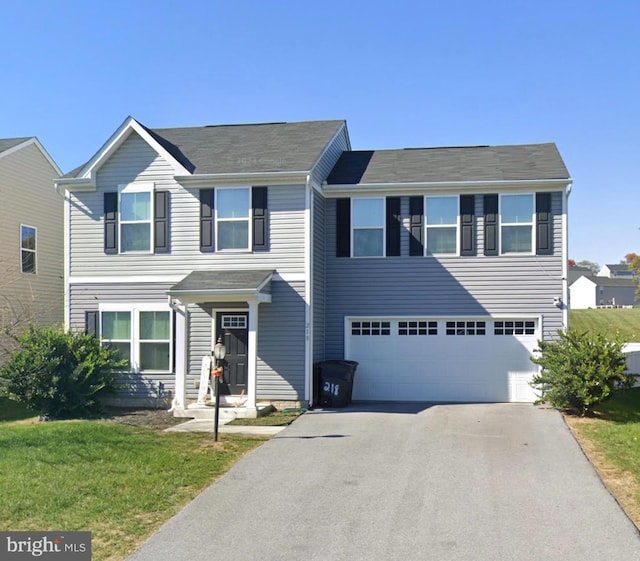 view of front of house featuring a garage and a front lawn