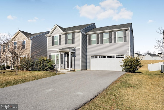 view of front of property with a garage, central air condition unit, and a front lawn